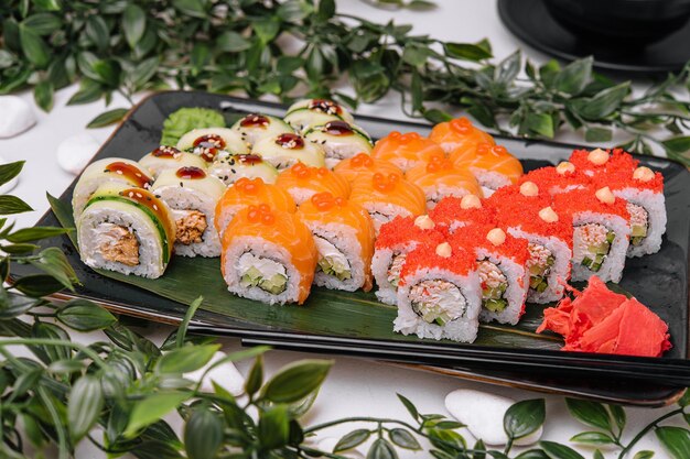 Sushi rolls on a black plate