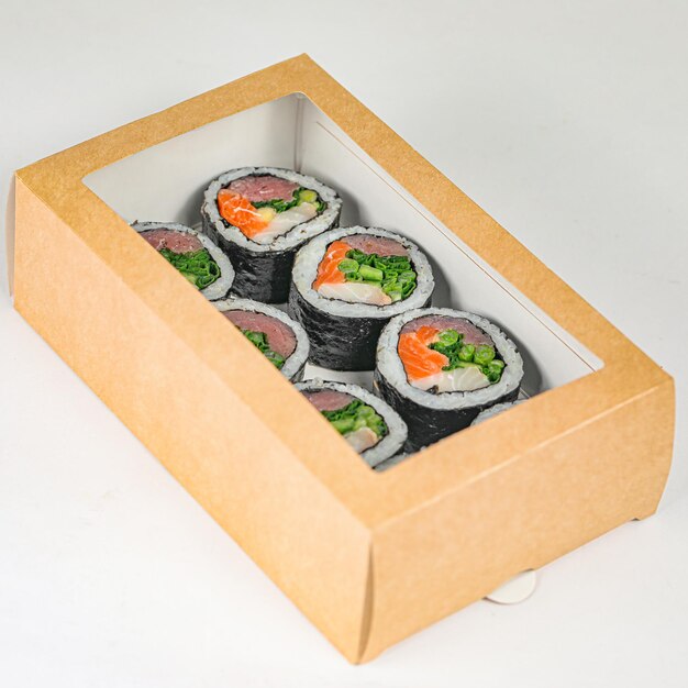 Sushi Rolls in Cardboard Box on White Surface