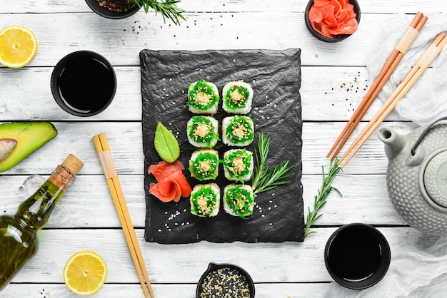 Photo sushi rolls  kyoto with salmon cucumber and chuka salad sushi menu bar japanese food