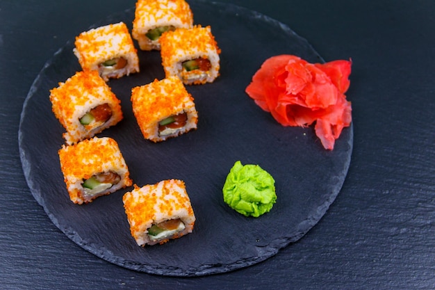 Sushi rolls Philadelphia on a black slate