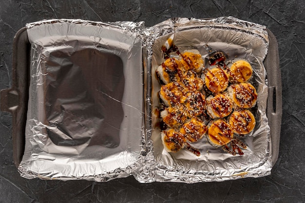 Sushi rolls in a plastic thermo container Takeaway food