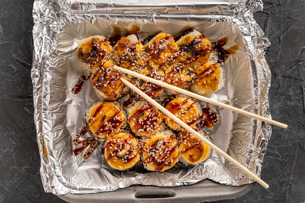 Sushi rolls in a plastic thermo container Takeaway food