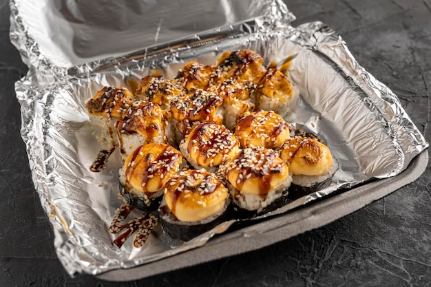 Sushi rolls in a plastic thermo container Takeaway food