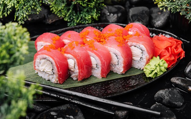 Sushi rolls of red tuna on black stone