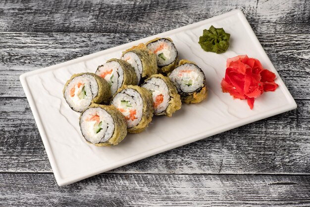 Sushi rolls sushi with fish on a white wooden background