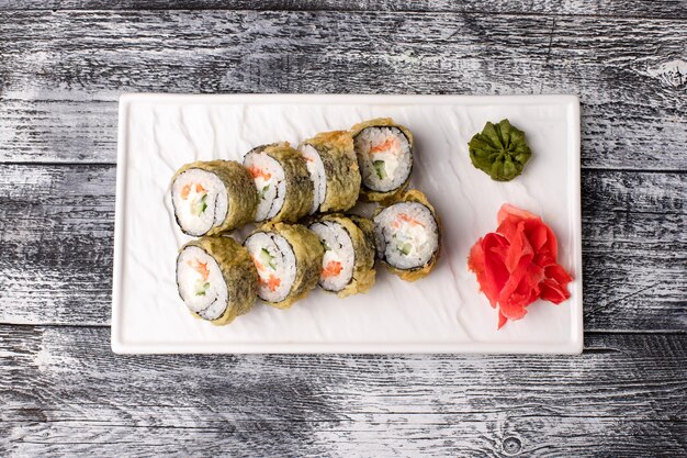 Sushi rolls sushi with fish on a white wooden background