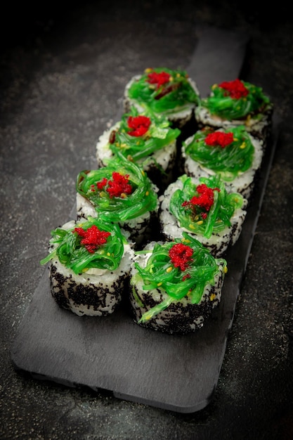 Sushi rolls with black and red caviar tobiko with green seaweed