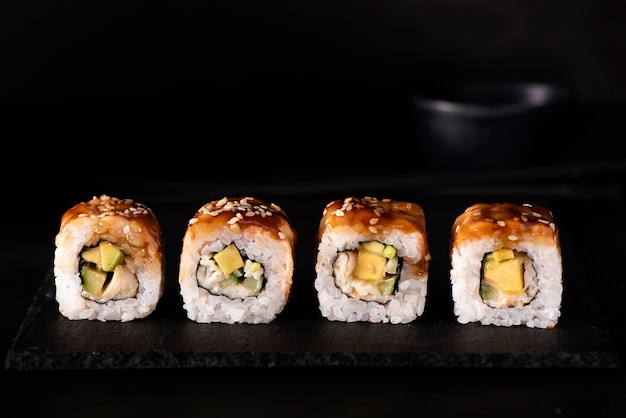 Sushi rolls with eel, crab, and mango