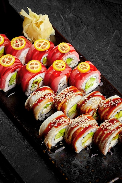 Sushi rolls with eel tuna cream cheese avocado cucumber unagi sauce