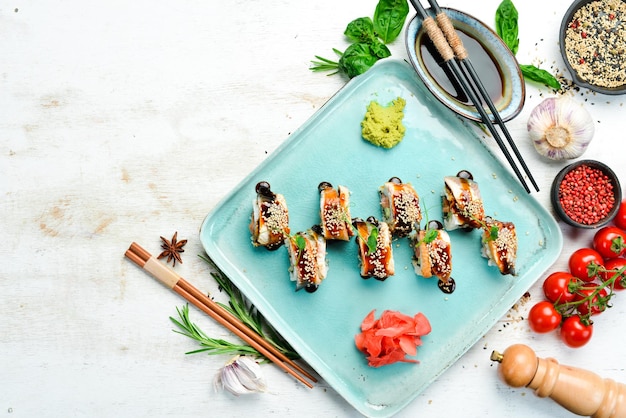 Sushi rolls with eel wasabi and soy sauce Japanese food Top view Rustic style