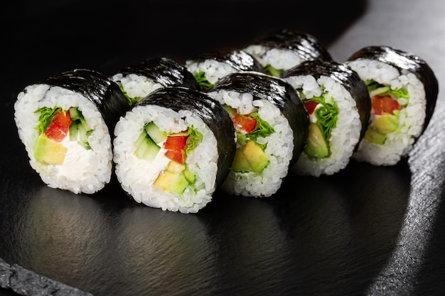 Sushi Rolls with salade, avocado, cucumber, pepper and Cream Cheese inside.