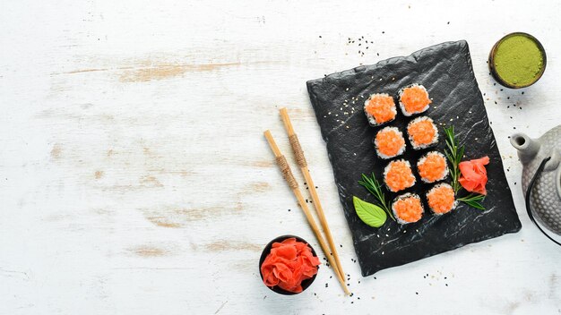 Sushi rolls with salmon and caviar Traditional Japanese cuisine Top view