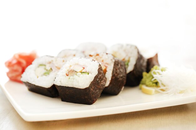 Sushi rolls on a wooden board