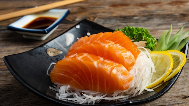 Sushi salmon tuna sushi shrimp and wasabi on the white plate isolatedselective focus