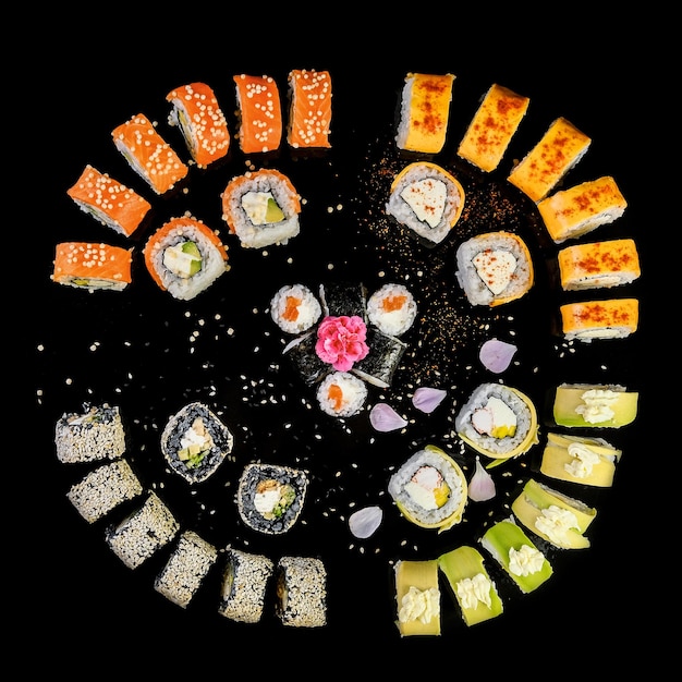 Photo sushi set on black background top view assortment of fresh mouthwatering sushi in an oriental restaurant