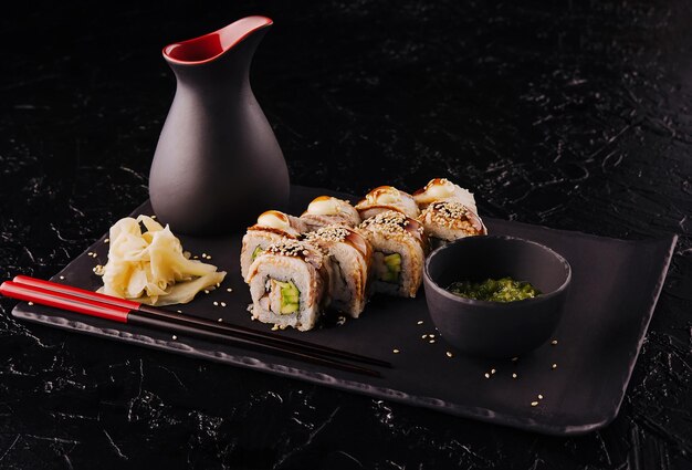 Sushi set canada roll with eel on black stone