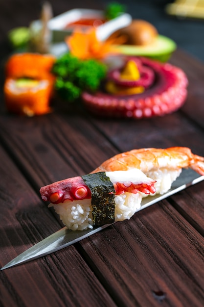 Photo sushi set. different sashimi, sushi and rolls with octopus