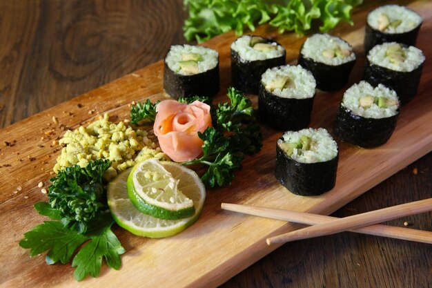 Sushi Set Different Types of Maki Sushi and Nigiri Sushi Served on dark wooden table