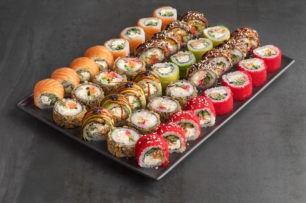 Sushi set Roll with fresh ingredients on stone background