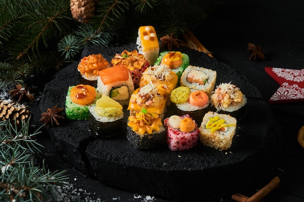 Sushi set and sushi roll on wooden board.