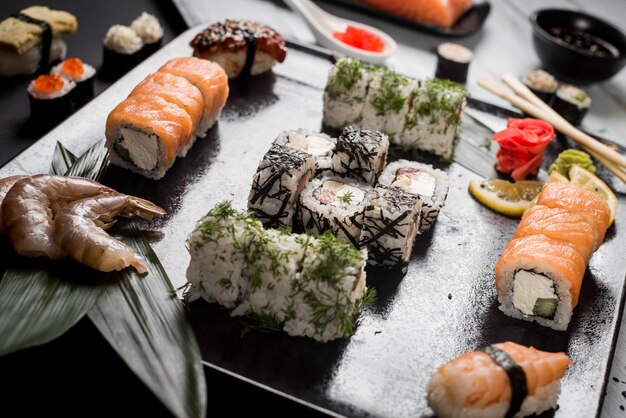 Sushi set with salmon eel tuna avocado cream cheese Philadelphia caviar chuka Sushi menu Japanese food on black and white background