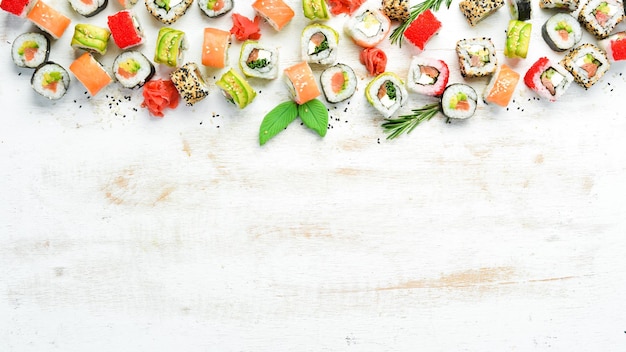 Sushi soy sauce wasabi and ginger on a white wooden background Japanese Traditional Cuisine Top view Rustic style