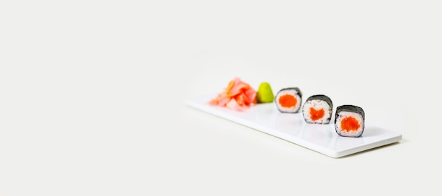 Sushi on a white plate on a white background isolated