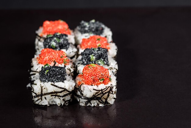 Sushi with caviar on black