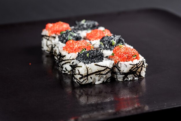 Sushi with caviar on black