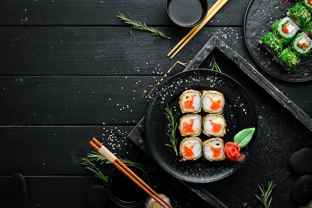 Sushi with crab and caviar cooked in oil Sushi menu of Japanese restaurant Top view