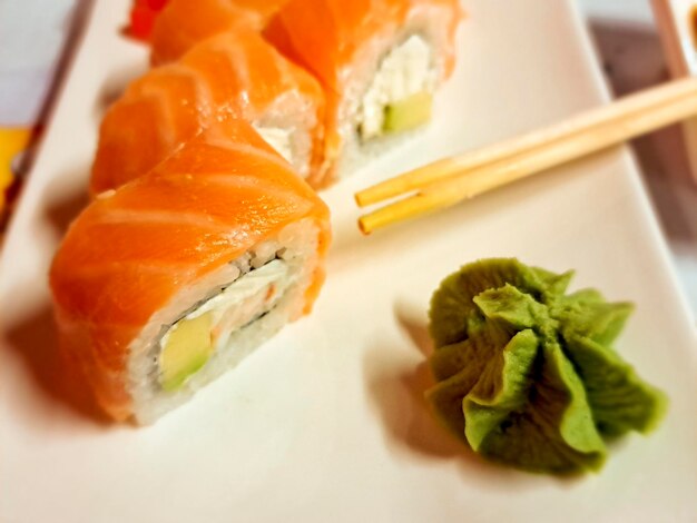 Sushi with salmon and wasabi on a white plate japanese and chinese food