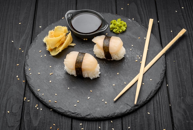 Sushi with scallop on a black