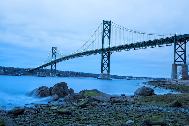 Suspension bridge against cloudy sky