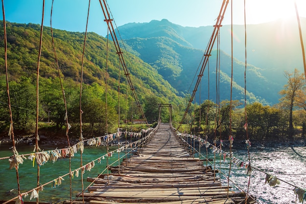 Suspension bridge over the mountain river Bzyb. Abkhazia, the road to Lake Ritsa.