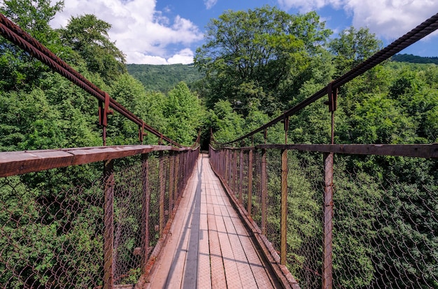 Suspension bridge over a mountain river in the Carpathians