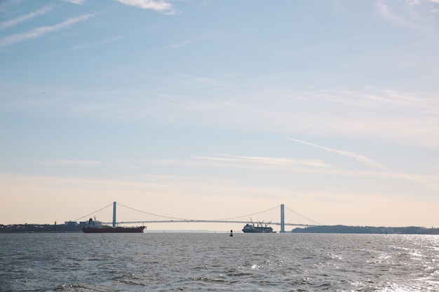 Suspension bridge over sea against sky