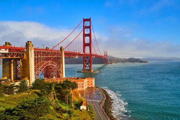 Suspension bridge over sea against sky