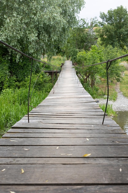 Suspension wooden bridge over the river