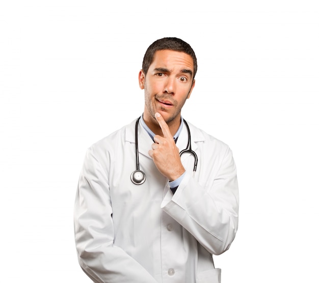 Suspicious doctor against white background