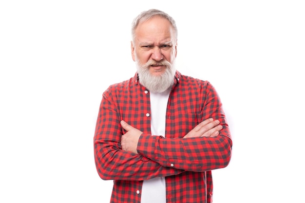 Suspicious sad s elderly grandfather man with gray beard and mustache crossed his arms