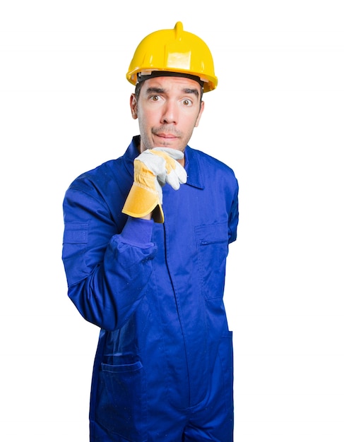 Suspicious workman on white background