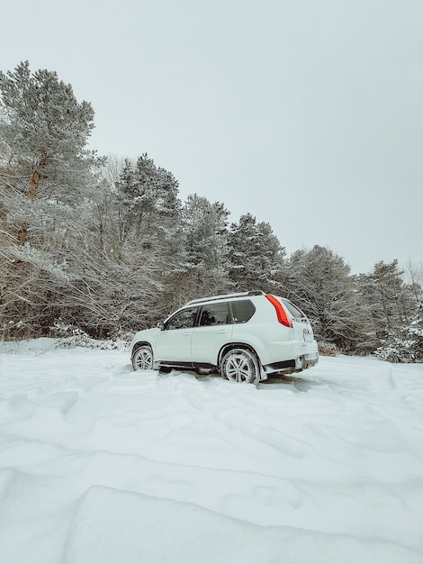 Suv car in the middle of snowed forest copy space