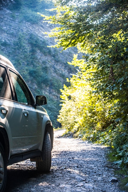 Suv car at mountains trail summertime