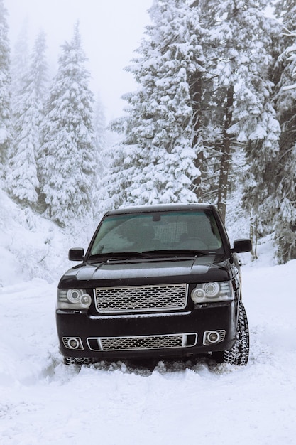 Suv car in snowed forest copy space