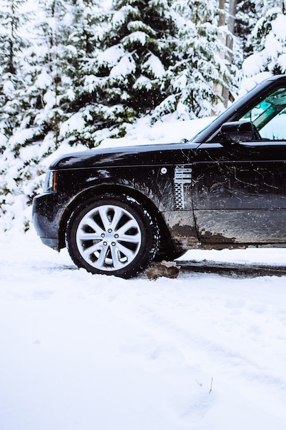 Suv car in snowed forest copy space