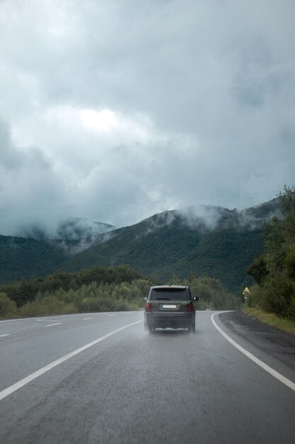 Suv car on the wet road in mountains