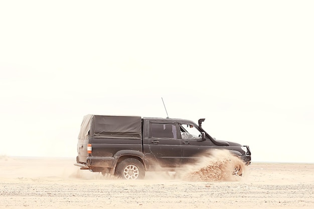 SUV in the desert / old vintage all-terrain vehicle, expedition in the desert on the sand, extreme cars