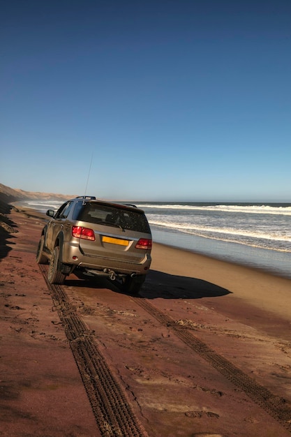 SUV on the ocean and near the desert in Namibia