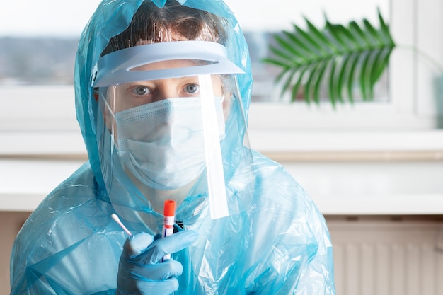 Swab test for coronavirus a doctor in a medical clinic with a tube before taking an analysis