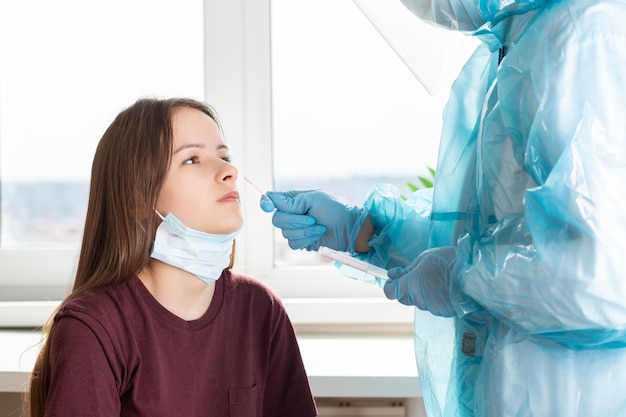 Swab test for coronavirus a doctor in a protective suit takes an analysis at a medical hospital